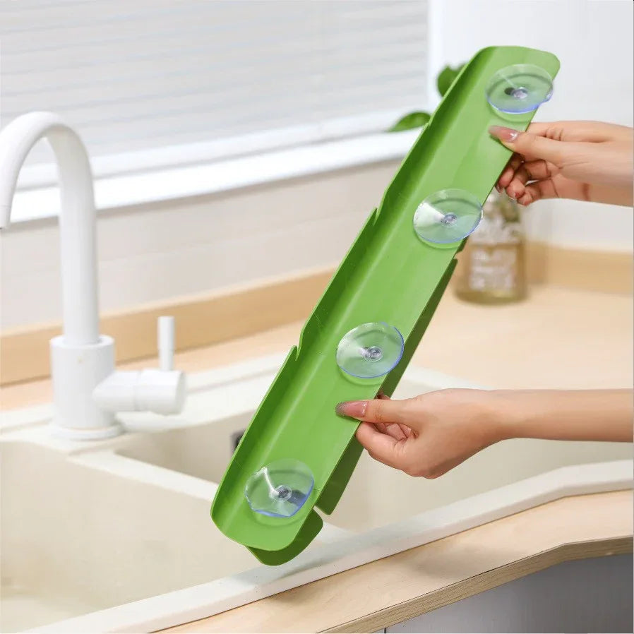 Yellow soft silicone splash guard attached to sink edge to prevent water splashes.
