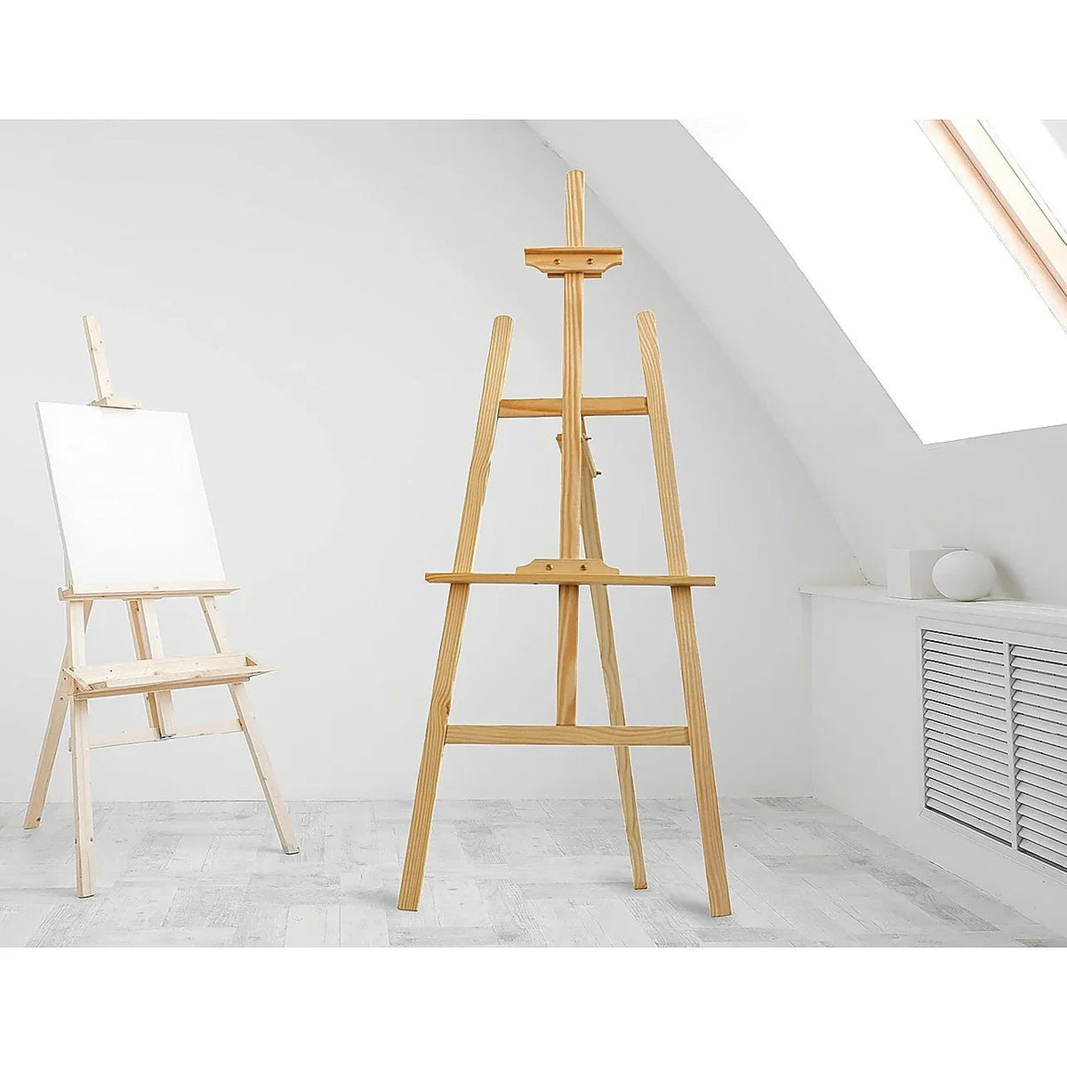 Adjustable pine wood artist easel with tripod stand holding a blank canvas in a bright indoor studio