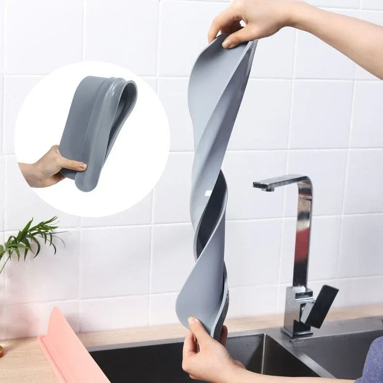 Black silicone splash-proof water baffle placed along sink edge to block water overflow.