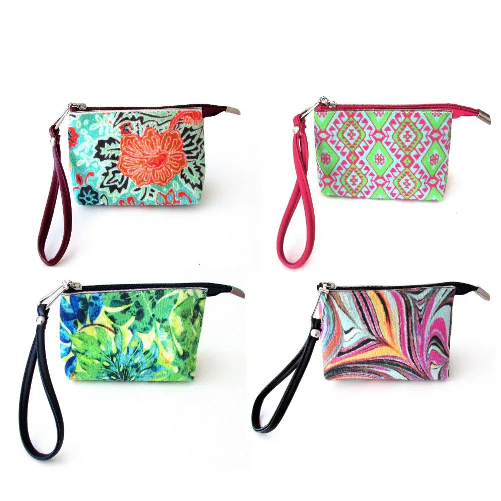 Red pomegranate patterned wristlet bag with wrist strap, standing upright on white background.
