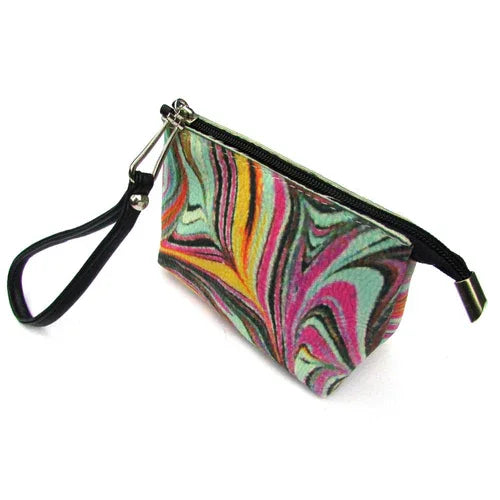 Woman’s hand holding red wristlet bag by its strap, showing portability and size scale.
