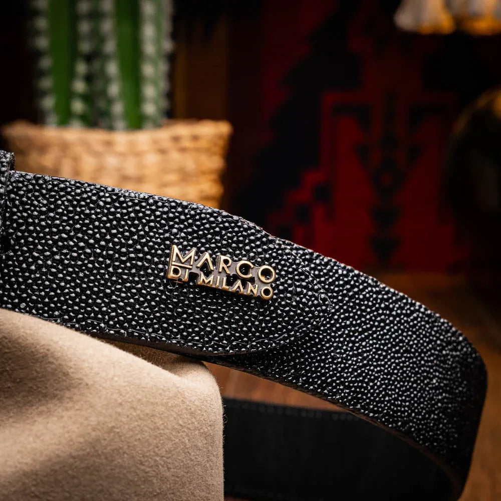 Close-up of black stingray belt worn around waist with jeans and white shirt
