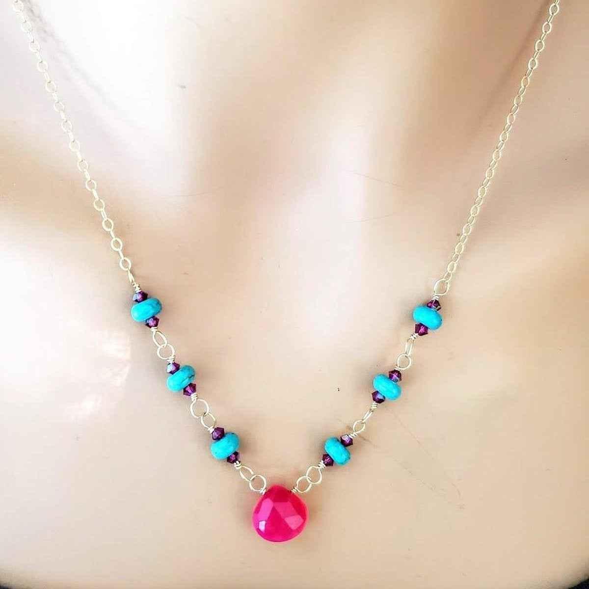 Detailed view of gold-filled necklace chain accented with turquoise and pink chalcedony gemstones.