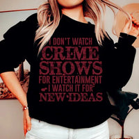 Black sweatshirt with white text saying 'I Don't Watch Crime Shows For Entertainment', displayed flat on light background.