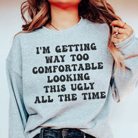 Sport grey sweatshirt with phrase 'I'm Getting Way Too Comfortable Looking This Ugly All The Time' in white and pink text.
