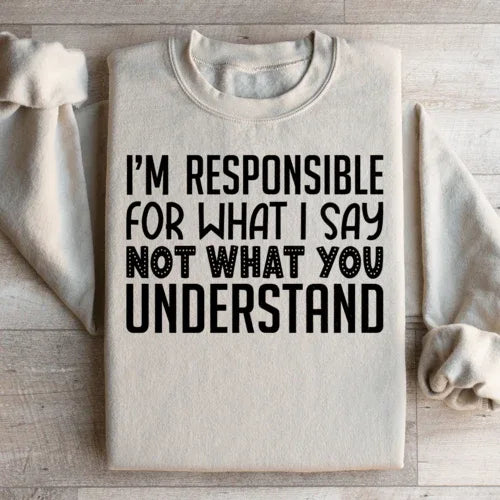Sand-colored sweatshirt displaying bold white text: 'I'm Responsible For What I Say Not What You Understand'.
