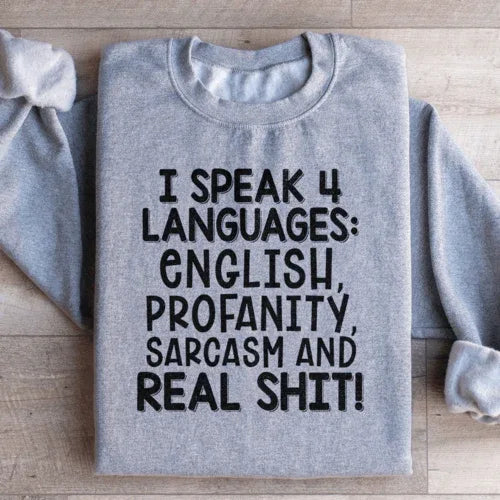 Peach colored sweatshirt with the phrase I Speak Four Languages printed in white text.
