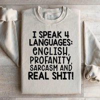 Front view of peach sweatshirt featuring the bold phrase I Speak Four Languages.
