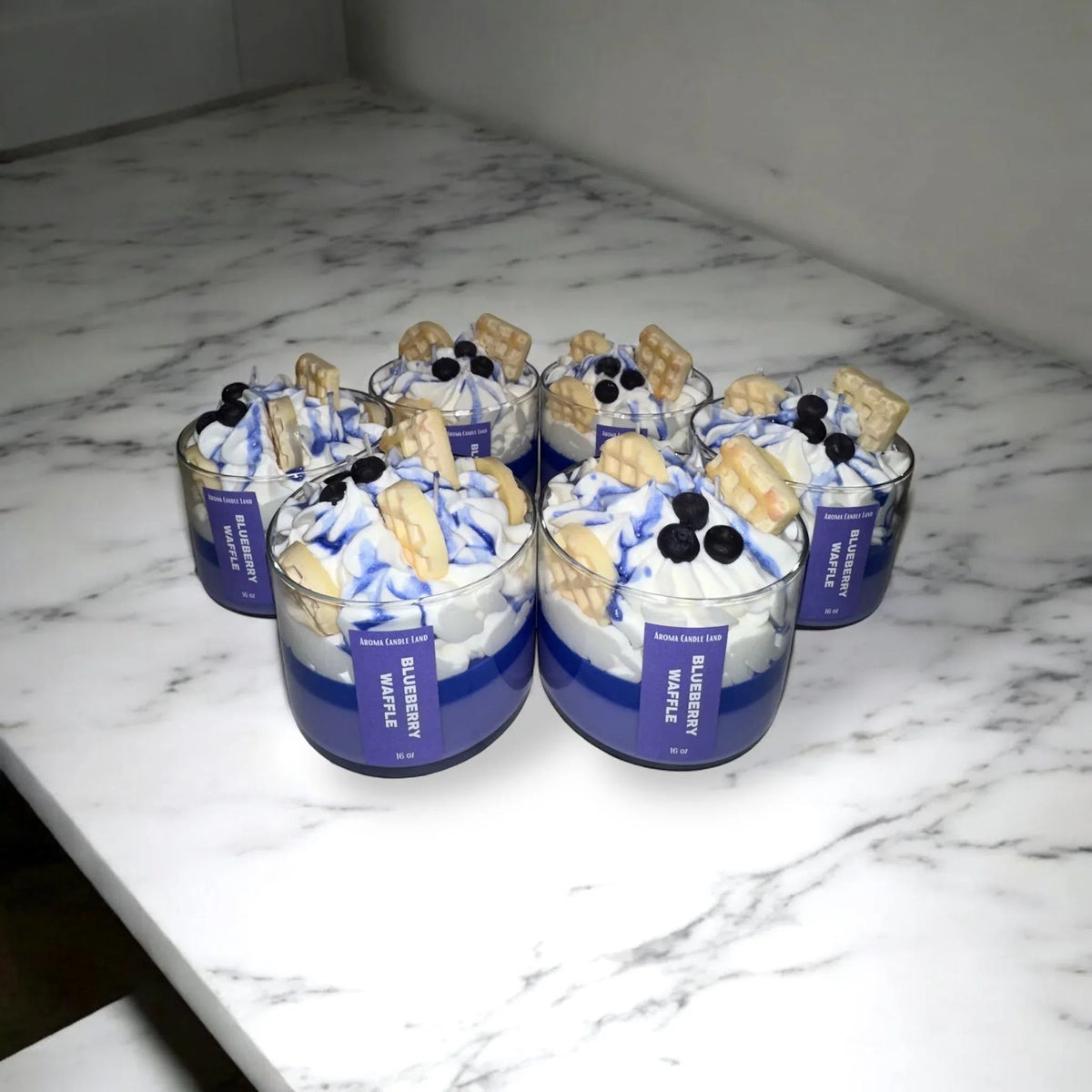 Several scented dessert candles in the shape of waffles with blueberries, perfect for gifts.