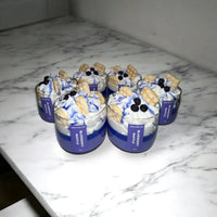 Several scented dessert candles in the shape of waffles with blueberries, perfect for gifts.