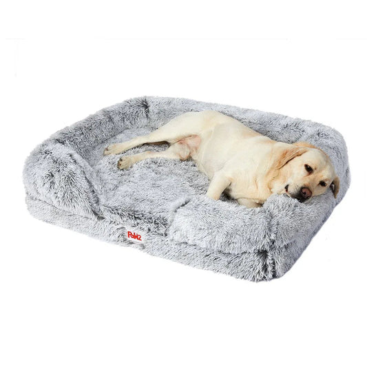 Orthopedic pet bed in soft beige plush fabric, shaped with supportive bolsters for dogs