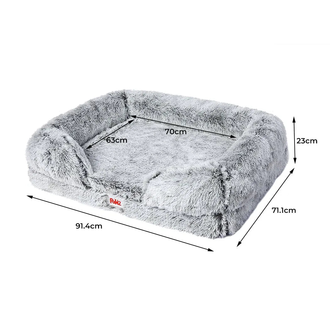 Orthopedic pet bed placed on wooden floor showcasing supportive bolster pillow