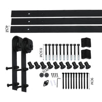 Close-up showing detailed metal rollers and track of vintage-style barn door hardware.