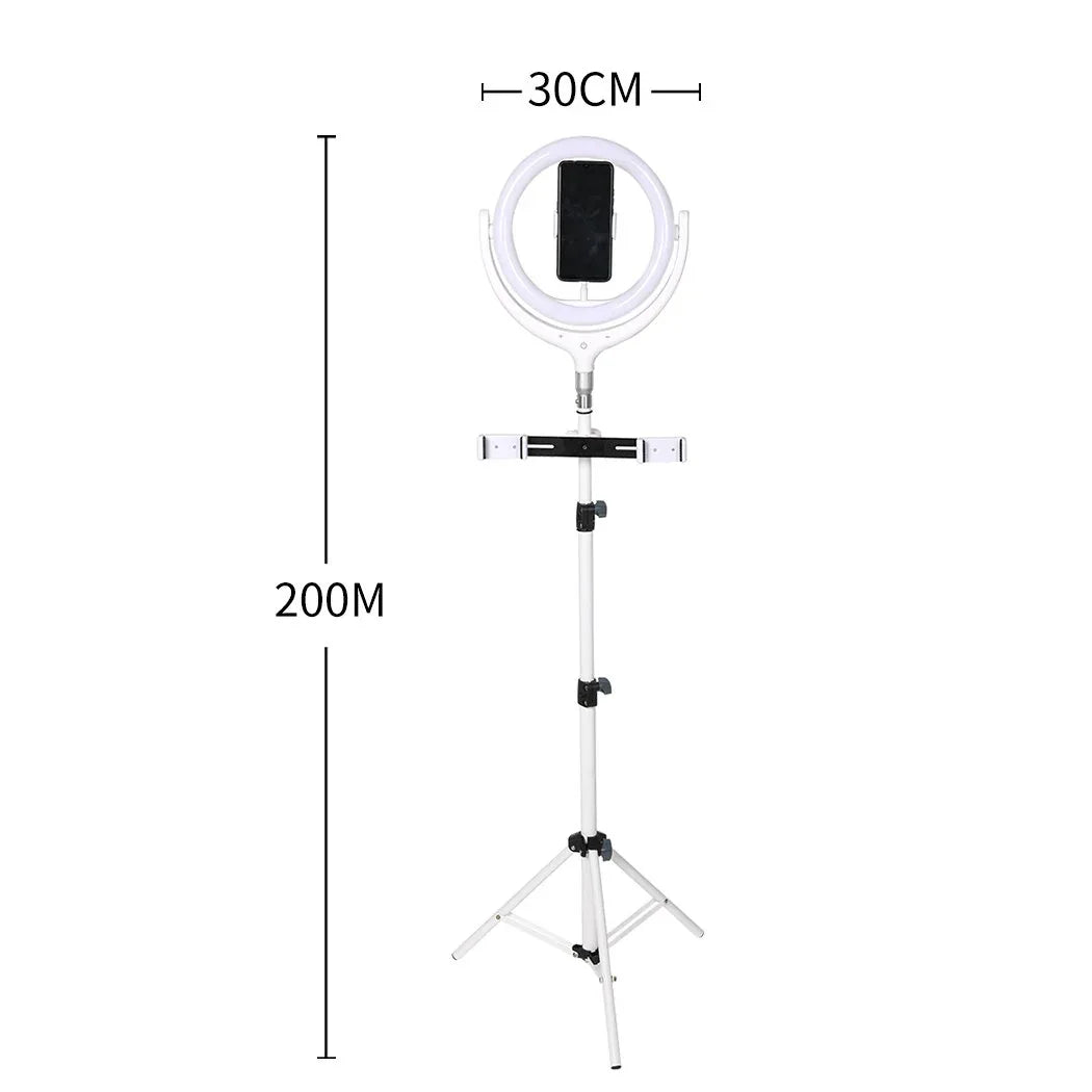 Compact LED ring light setup with adjustable tripod stand and phone holder in a bright studio setting.