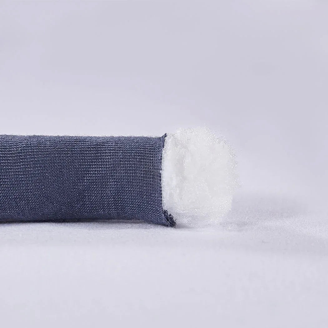 Hand gently touching the chunky knit blanket to demonstrate its soft and smooth texture.