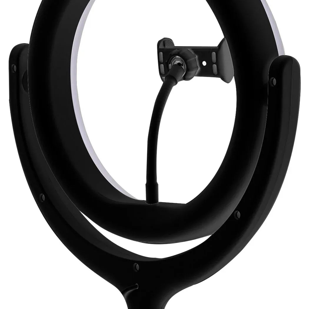 LED ring light tripod set on a desk with bright, adjustable lighting illuminating workspace.