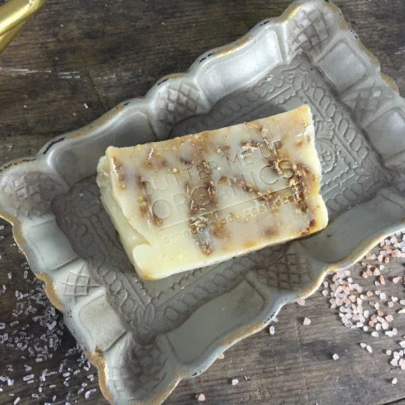 Stack of oat and honey soap bars with visible oats and honey golden hues.