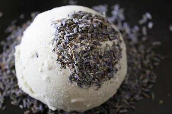 Lavender-scented bath bomb packaging with natural ingredients illustration and brand logo.