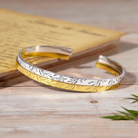 Close-up of the sterling silver bridesmaid bracelet showing delicate engraving details.