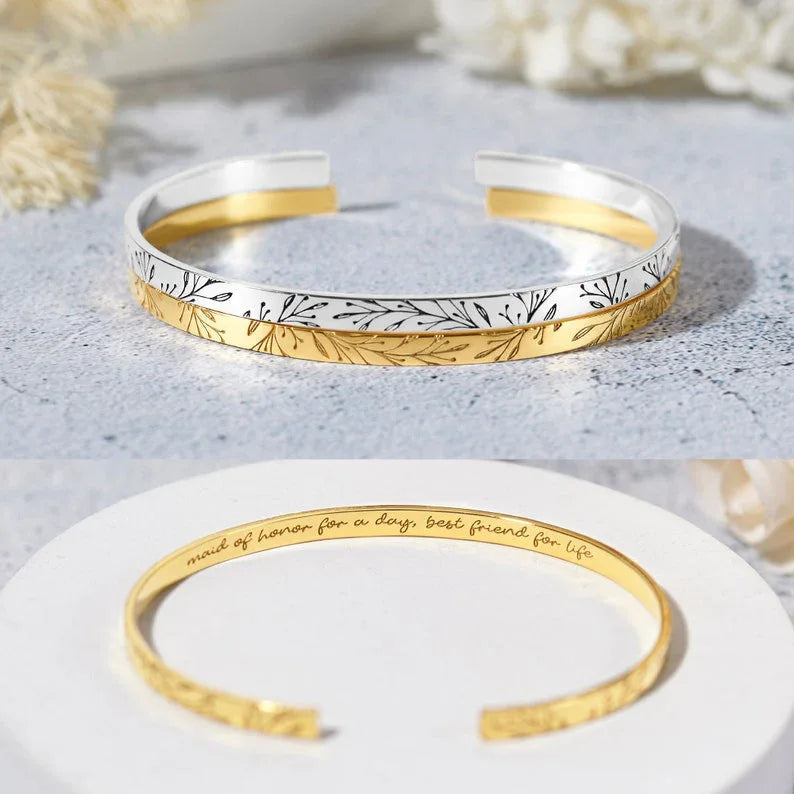 Bridesmaid bracelet displayed on a textured surface, highlighting its sleek, polished design.
