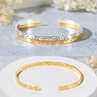 Bridesmaid bracelet displayed on a textured surface, highlighting its sleek, polished design.