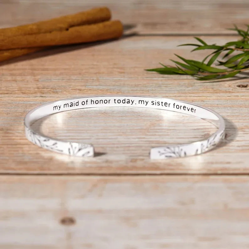 Hand wearing the sterling silver cuff bracelet, demonstrating its feminine and timeless style.