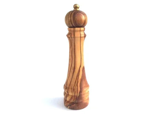 Wooden pepper mill with a clear metallic top, shown in natural lighting.