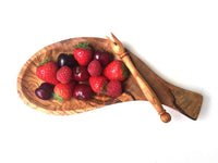 Rectangular serving platter with integrated handles and skewers on wooden surface.
