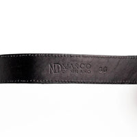 Black caiman crocodile belt displayed flat to showcase scale patterns and craftsmanship