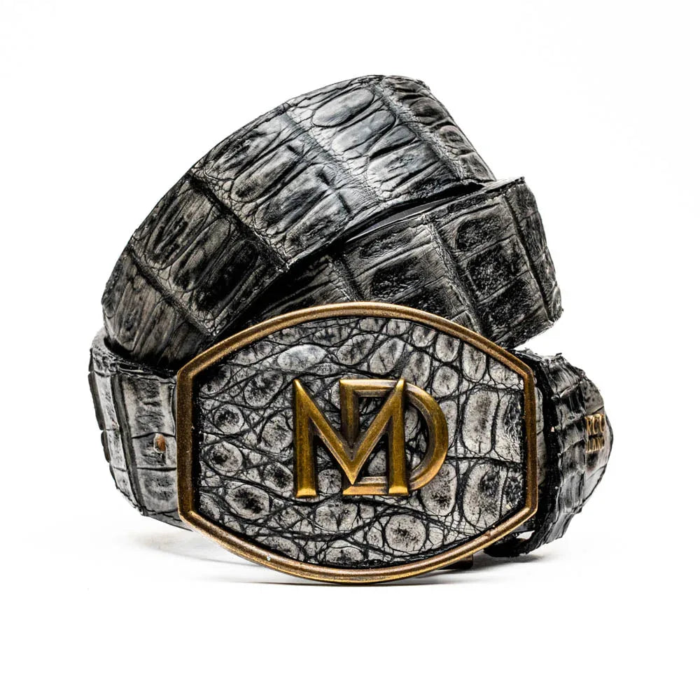 Close-up of gray caiman crocodile belt showing natural scale texture and antique brass buckle.