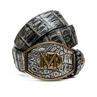 Close-up of gray caiman crocodile belt showing natural scale texture and antique brass buckle.