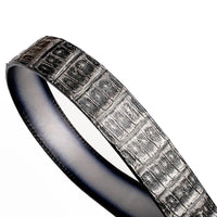 Flat lay of gray caiman skin belt showing overall length and grain detail.