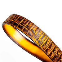 Close-up showing gradient hand-stained leather lining inside the mustard brown caiman belt