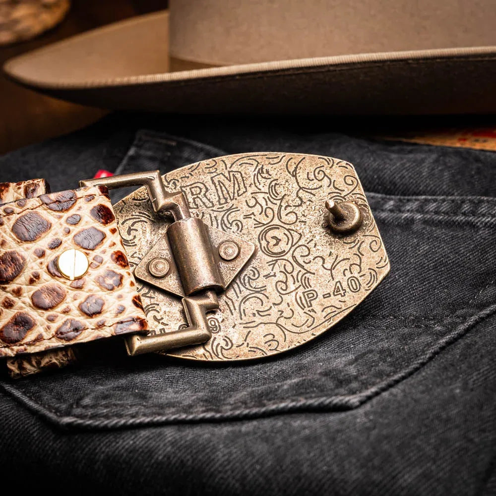Lifestyle shot of belt styled with rugged jeans and leather jacket in an outdoor setting.