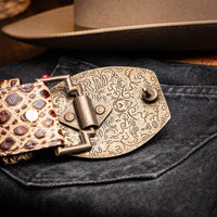 Lifestyle shot of belt styled with rugged jeans and leather jacket in an outdoor setting.