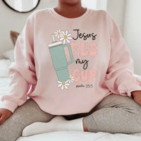 Light pink sweatshirt with black "Jesus Fills My Cup Psalm" text design on front.