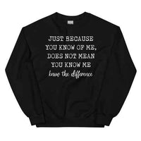 Close-up of black sweatshirt with white text saying 'Just Because You Know Me Does Not Mean You Know Me'.