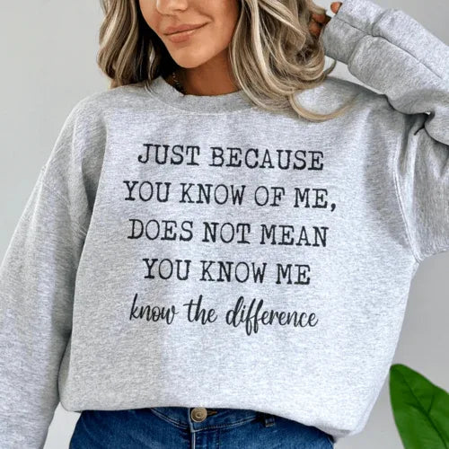 Peach sweatshirt showing bold white quote 'Just Because You Know Me Does Not Mean You Know Me' in front.