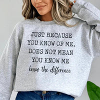 Peach sweatshirt showing bold white quote 'Just Because You Know Me Does Not Mean You Know Me' in front.