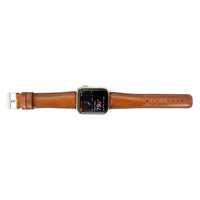Leather Apple Watch band laid out with buckle and strap holes visible.