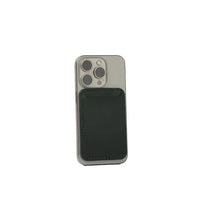 Forest green handcrafted leather MagSafe wallet for iPhone resting on white surface.