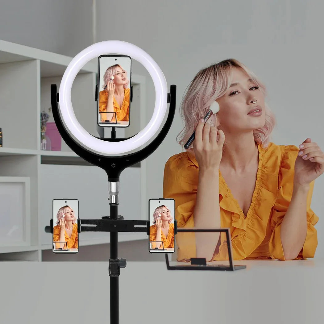 Lifestyle image of person using the LED ring light with tripod stand and phone holder for selfie.