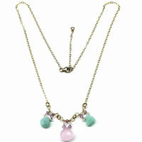 Handcrafted 14 K gold filled necklace displayed on white background highlighting pink and mint green gems