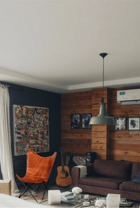 Close-up of brown leather seat and rustic iron frame of butterfly chair in industrial style