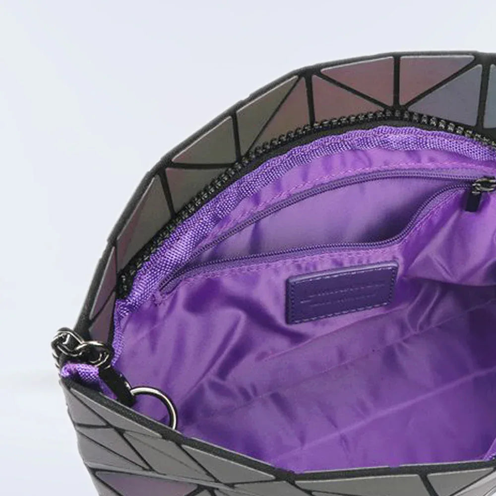 Lumination Holographic Purse held by a hand showing its compact and lightweight design.