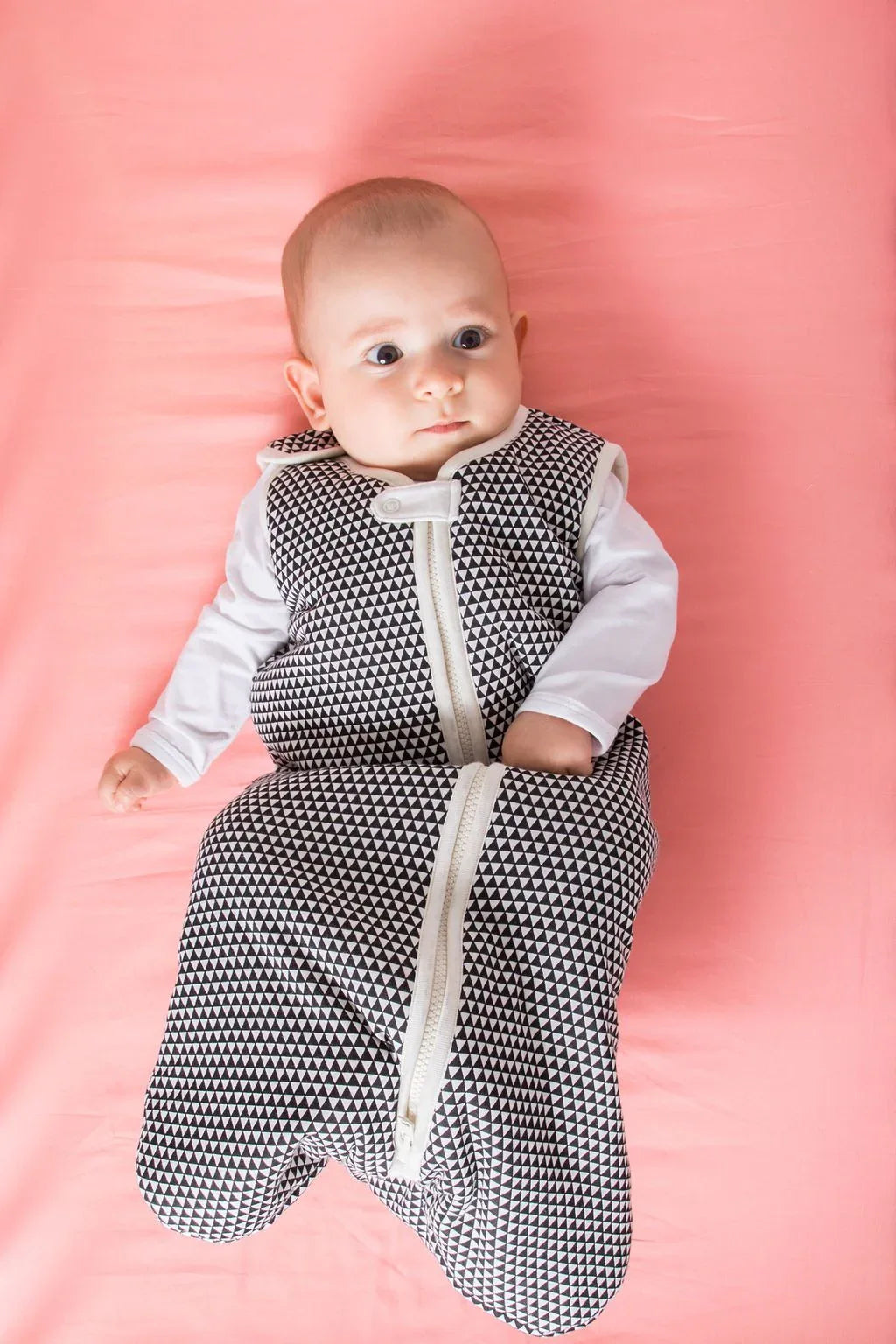 Close-up of the lightweight wearable baby sleep bag fabric showing texture and stitching.
