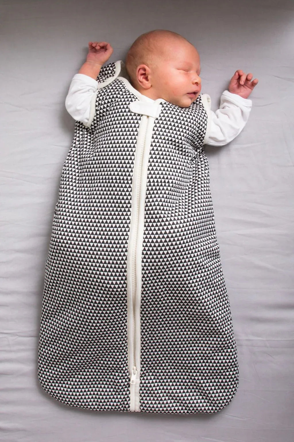 Baby wearing the lightweight Greenwich sleep bag, demonstrating comfort and fit.
