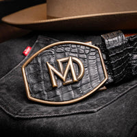 Model dressed casually featuring Marlboro black genuine hornback caiman belt in outdoor environment.