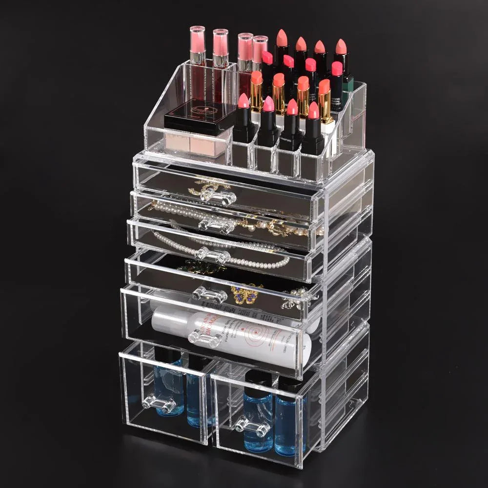 Close-up of clear acrylic drawers containing makeup and jewelry items