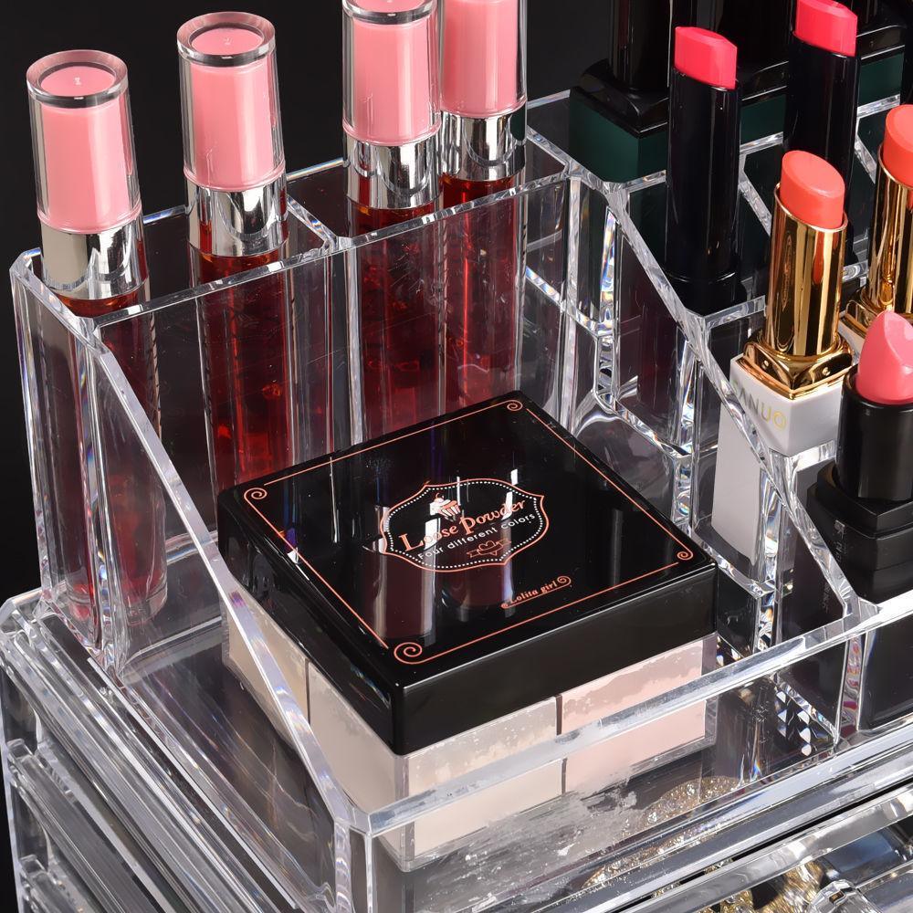 Side view of transparent makeup and jewelry storage box with open drawer